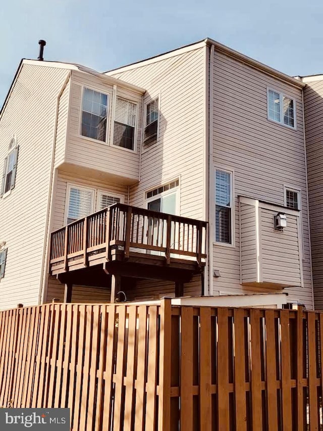 rear view of property with fence