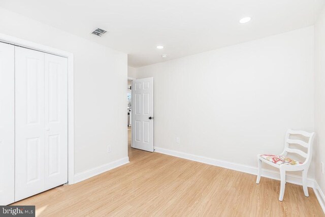 unfurnished room with light wood-style flooring, recessed lighting, visible vents, and baseboards