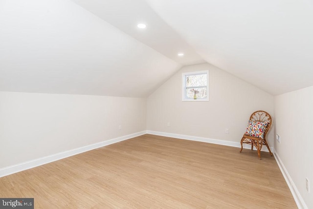 bonus room featuring light wood-type flooring, recessed lighting, baseboards, and lofted ceiling