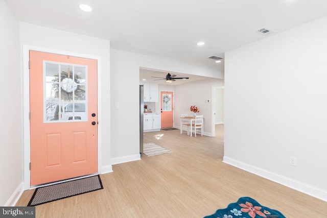 foyer entrance featuring light wood-type flooring, visible vents, baseboards, and recessed lighting