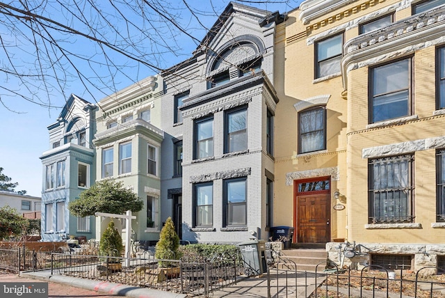 multi unit property featuring fence and brick siding