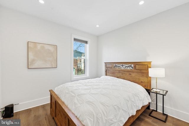 bedroom featuring baseboards, dark wood finished floors, and recessed lighting