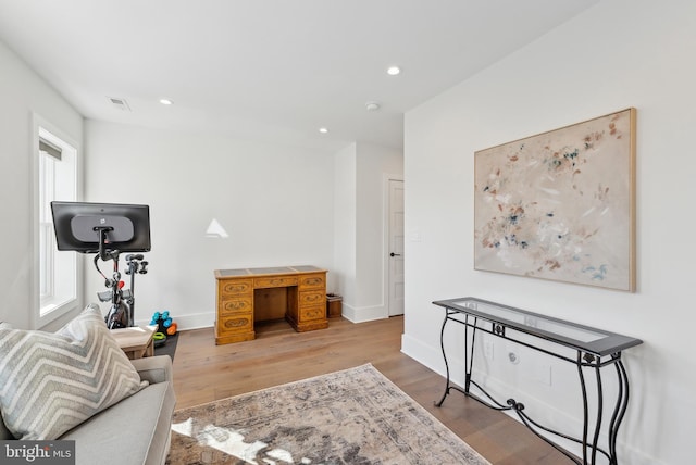 interior space with baseboards, recessed lighting, visible vents, and light wood-style floors