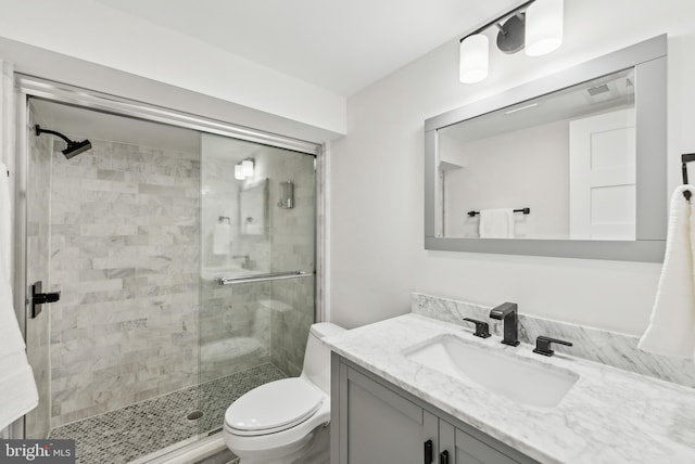 full bath featuring vanity, a shower stall, and toilet