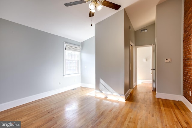 unfurnished room featuring visible vents, high vaulted ceiling, light wood-style flooring, and baseboards