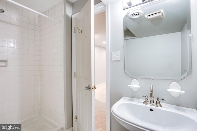 bathroom featuring a sink, visible vents, and a shower stall