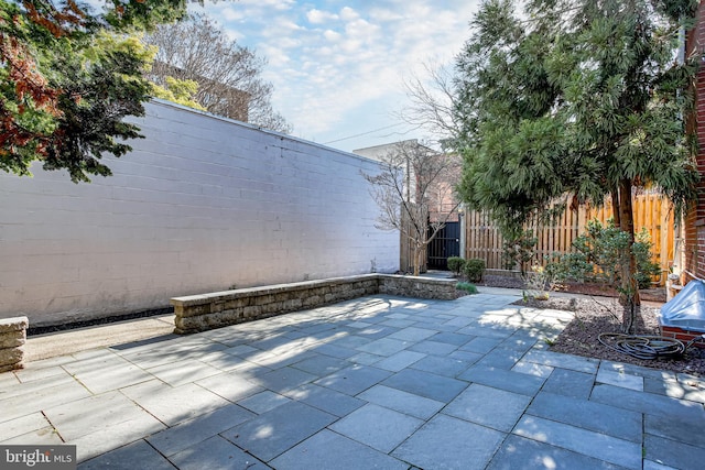 view of patio / terrace featuring fence