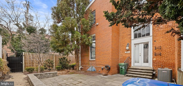 exterior space featuring entry steps, central AC, and fence