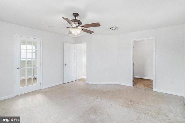 unfurnished room featuring light carpet, baseboards, and a ceiling fan