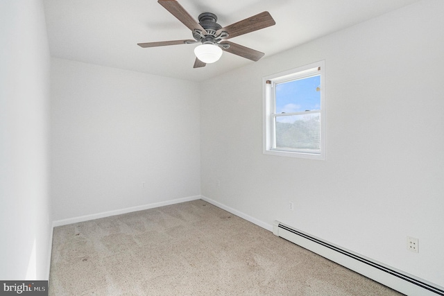 spare room featuring a baseboard heating unit, baseboards, a ceiling fan, and light colored carpet