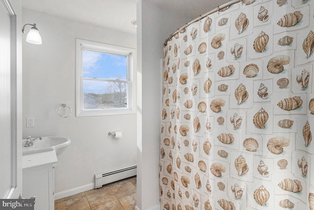 bathroom with curtained shower, tile patterned flooring, vanity, baseboards, and baseboard heating