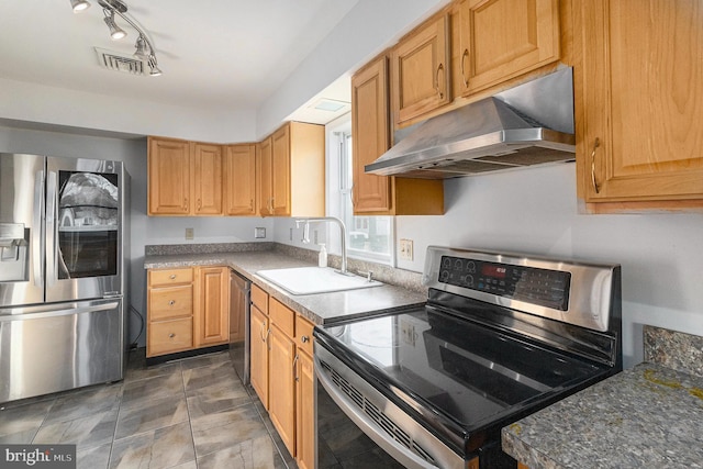 kitchen featuring appliances with stainless steel finishes, a sink, visible vents, and under cabinet range hood