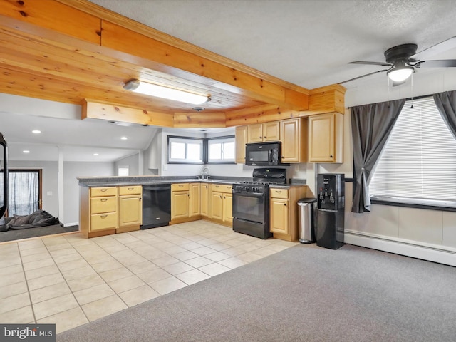 kitchen with dark countertops, open floor plan, beamed ceiling, light brown cabinetry, and black appliances