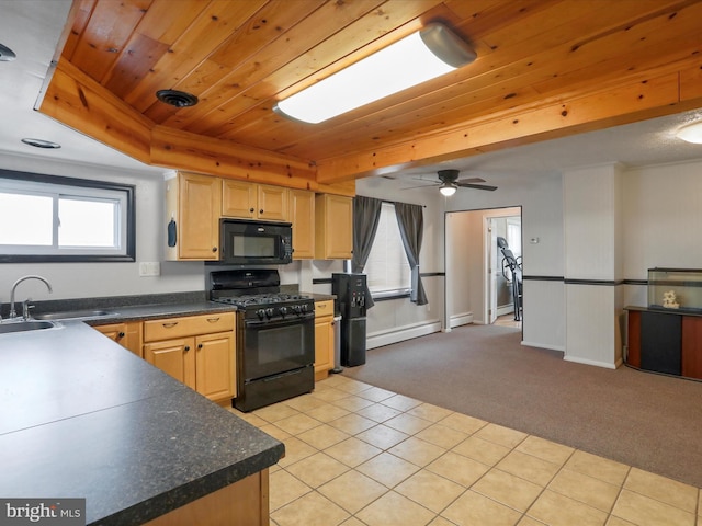 kitchen with dark countertops, wood ceiling, light carpet, a sink, and black appliances