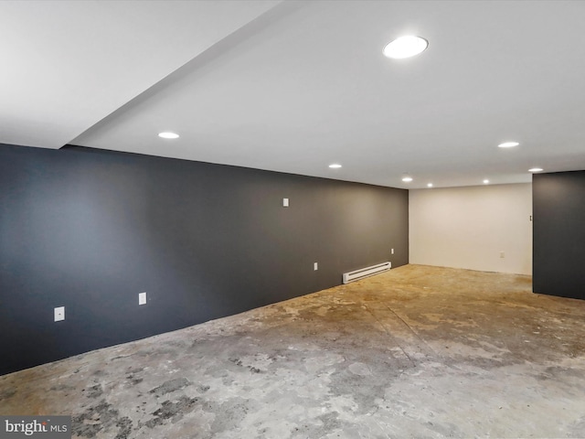 finished below grade area featuring recessed lighting and baseboard heating