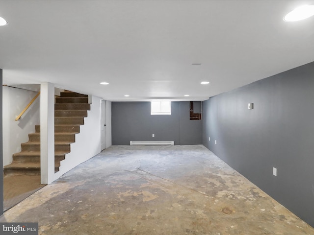 basement featuring stairway and baseboard heating