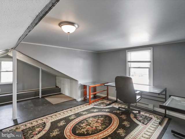 office with a healthy amount of sunlight, finished concrete flooring, baseboards, and lofted ceiling