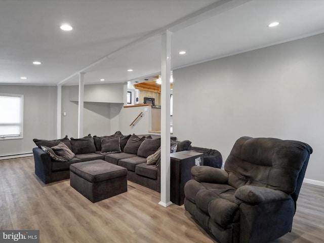 living area with light wood-type flooring, baseboards, and recessed lighting