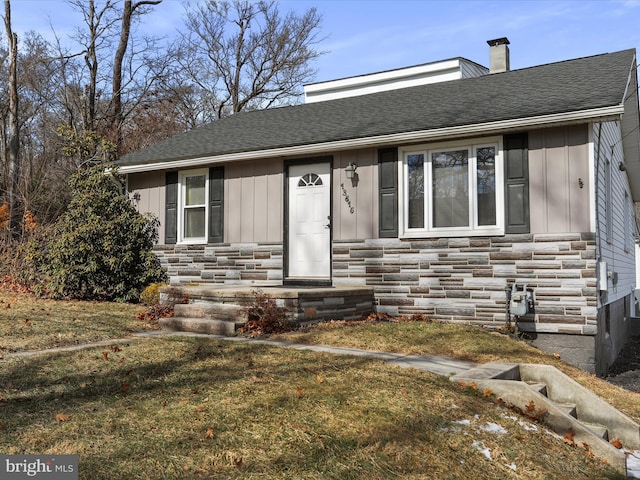 single story home featuring board and batten siding, entry steps, and stone siding