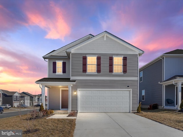 traditional-style home with driveway and an attached garage