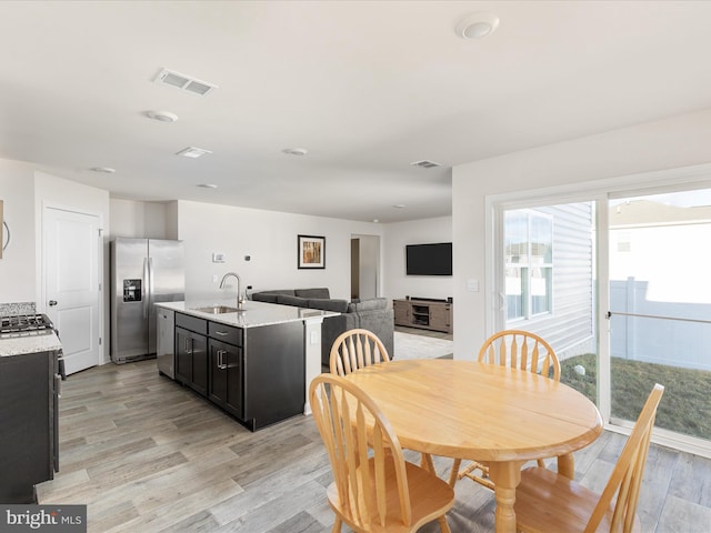 dining room with visible vents and light wood-style flooring