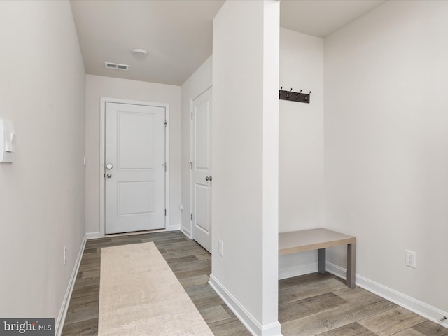 interior space featuring wood finished floors, visible vents, and baseboards