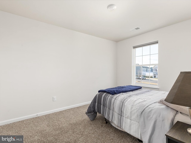 bedroom featuring baseboards, visible vents, and carpet flooring