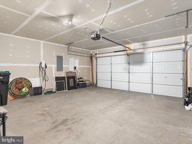 garage with electric panel and a garage door opener