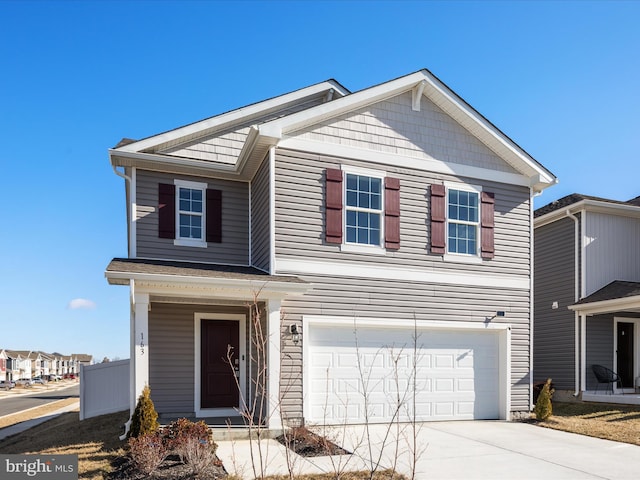 view of front of property with a garage and concrete driveway