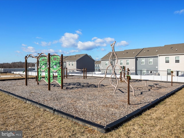 community play area with a residential view and fence