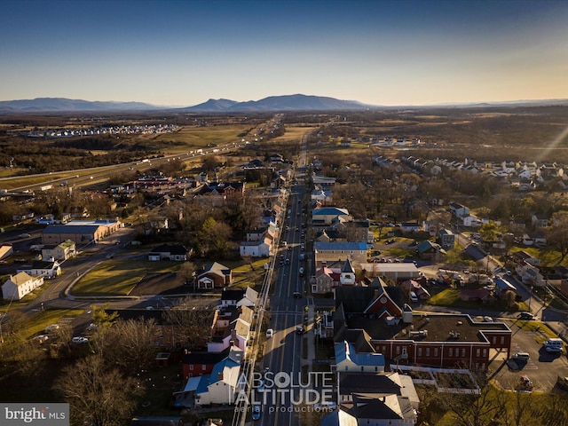 aerial view at dusk featuring a residential view and a mountain view