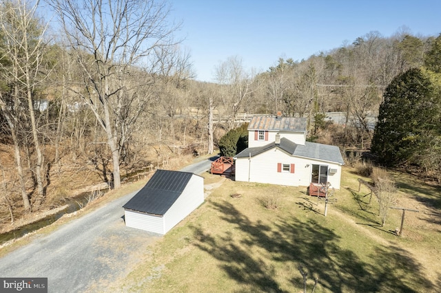 birds eye view of property with a wooded view