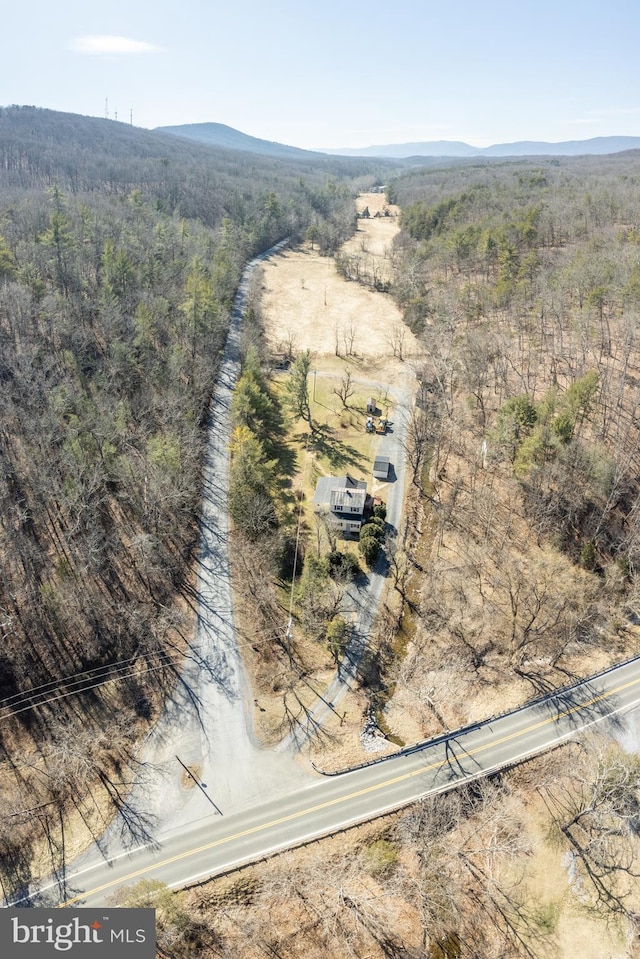 bird's eye view with a mountain view and a wooded view