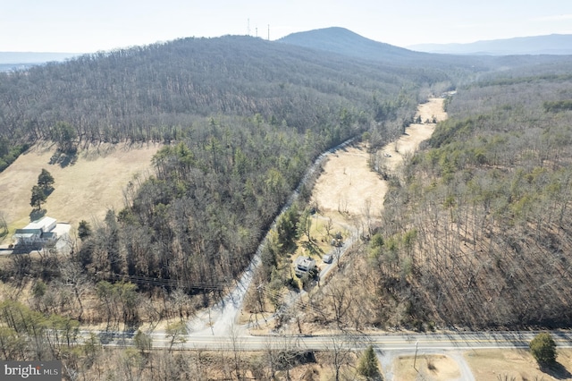 drone / aerial view with a forest view and a mountain view