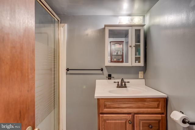 bathroom featuring an enclosed shower and vanity