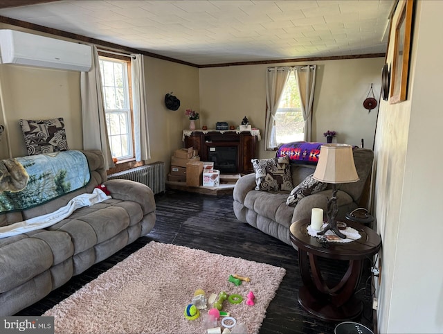 living area with an AC wall unit, ornamental molding, radiator heating unit, and a healthy amount of sunlight