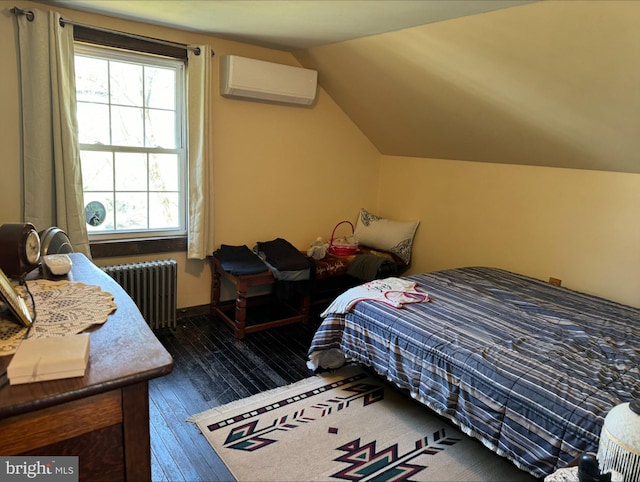 bedroom with baseboards, lofted ceiling, dark wood-style floors, radiator heating unit, and a wall mounted air conditioner