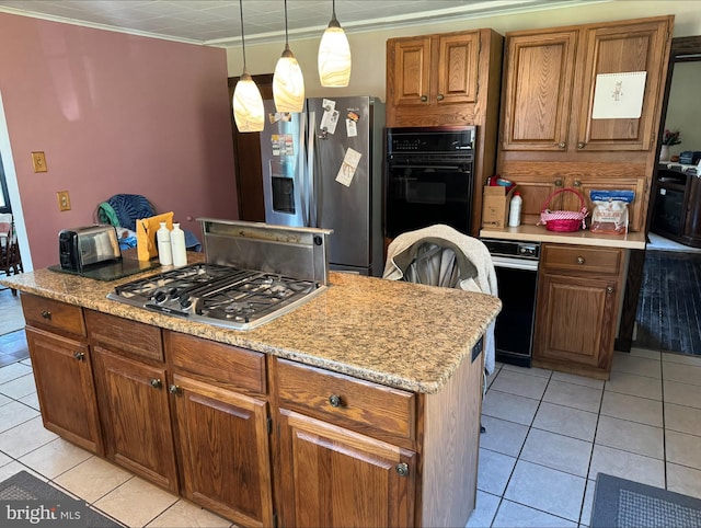 kitchen featuring brown cabinets, light tile patterned floors, appliances with stainless steel finishes, and pendant lighting