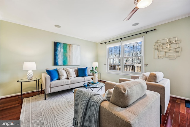 living room with crown molding, baseboards, ceiling fan, and wood finished floors