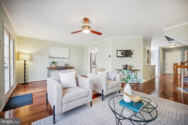 living area featuring baseboards, crown molding, hardwood / wood-style floors, and ceiling fan