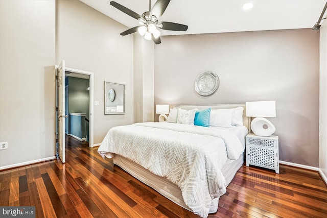 bedroom with high vaulted ceiling, a ceiling fan, baseboards, and hardwood / wood-style flooring