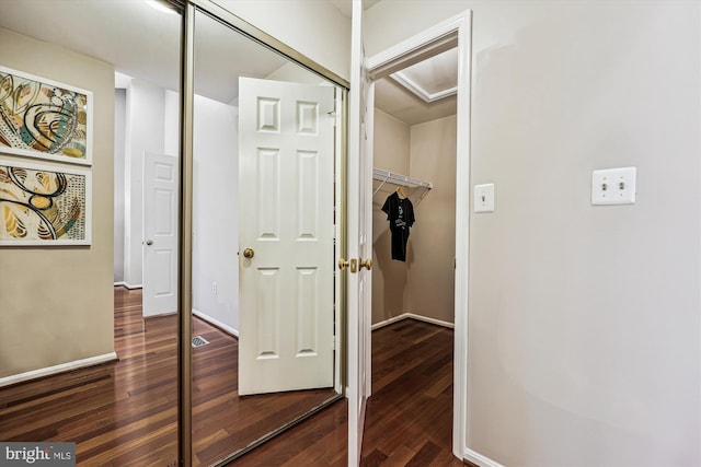 hallway with baseboards and dark wood-style flooring