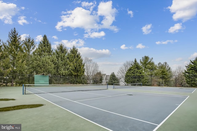 view of tennis court featuring fence