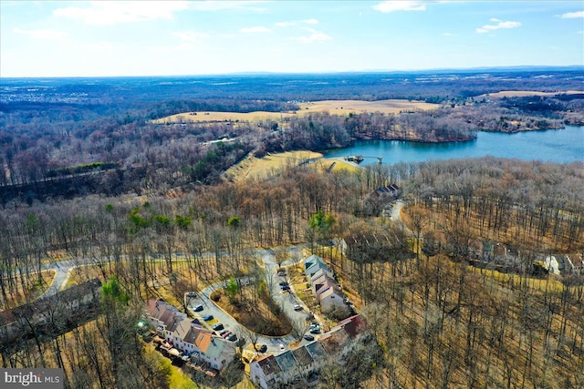 drone / aerial view featuring a water view and a forest view