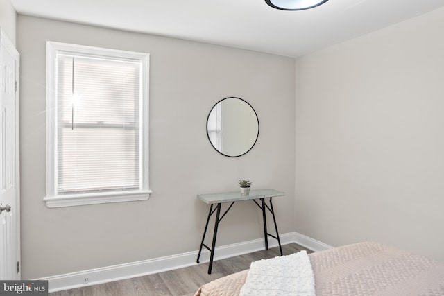 bedroom featuring baseboards and wood finished floors