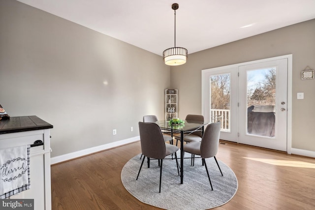 dining room with baseboards and wood finished floors