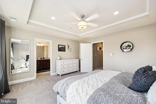 bedroom with light carpet, visible vents, a tray ceiling, and baseboards