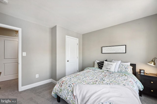 carpeted bedroom featuring baseboards