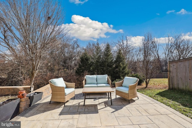 view of patio featuring fence and an outdoor living space