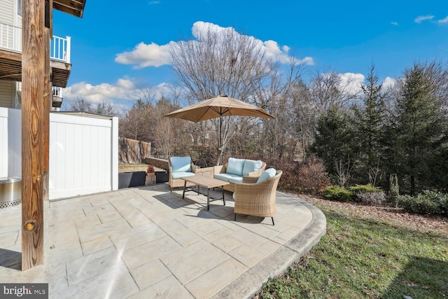 view of patio / terrace with an outdoor hangout area and fence